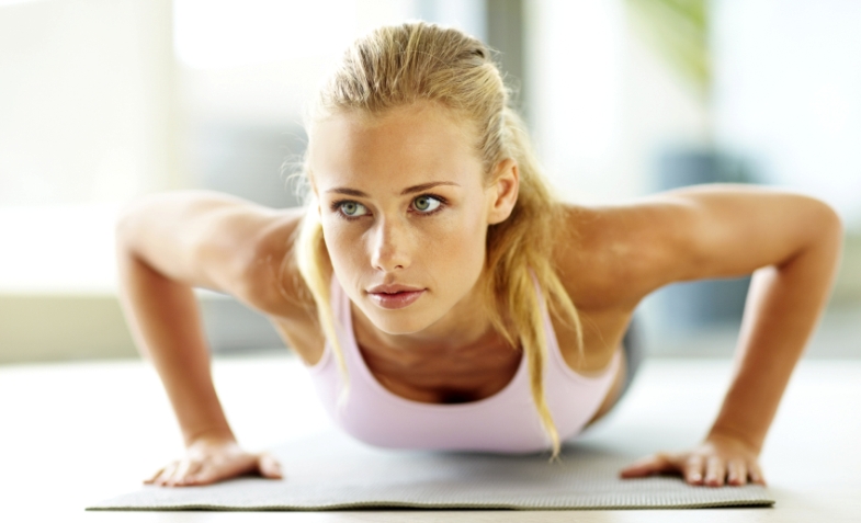 Push ups - Attractive young female doing exercise